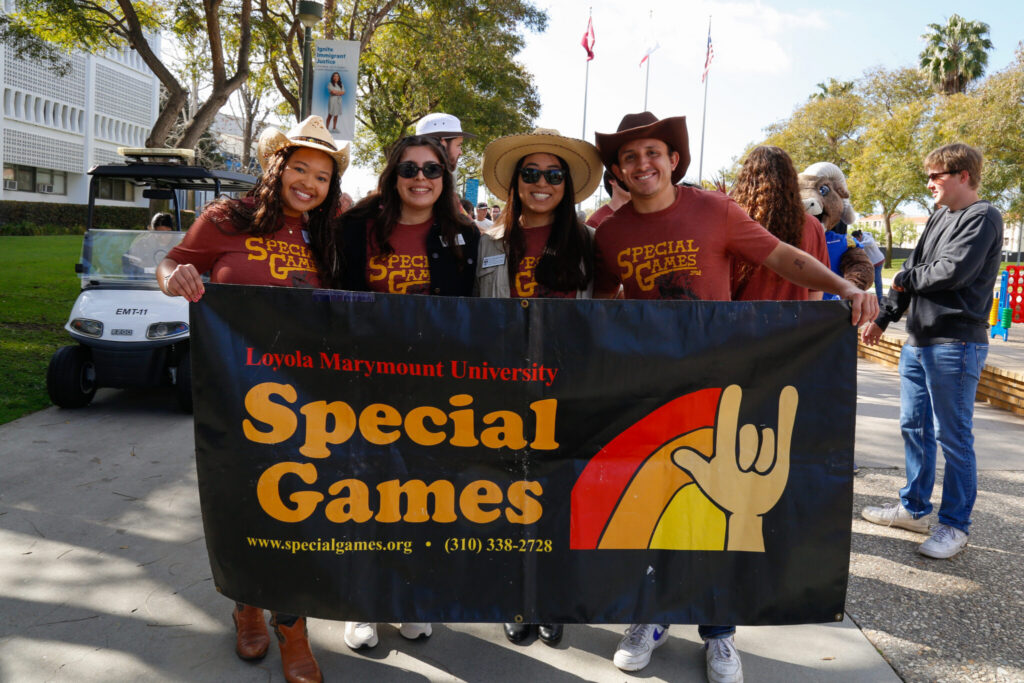 LMU Students holding Special Games Banner on Alumni Mall