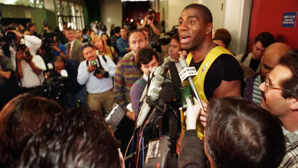 Magic Johnson speaks with reporters in LMU Gersten Pavilion following a personal practice January 1996. (Al Seib / Los Angeles Times)